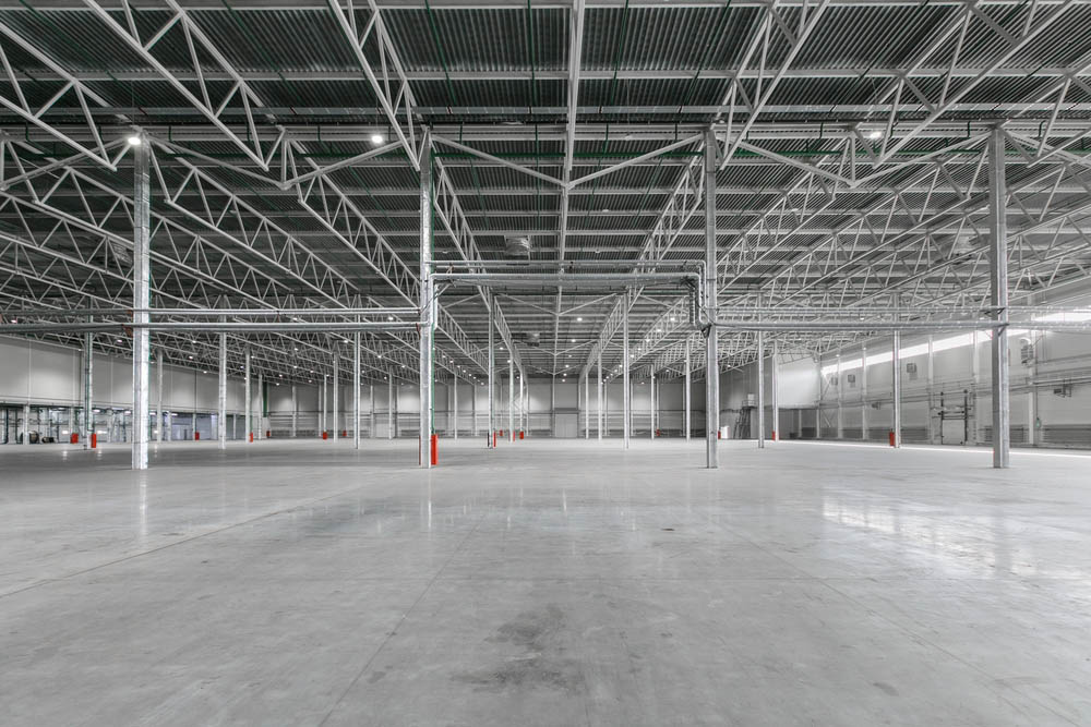 Polished concrete floor seen in interior of empty warehouse or garage